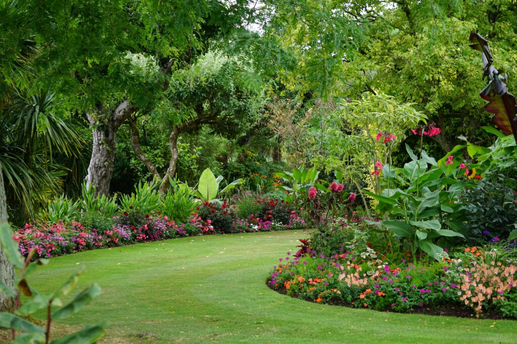 A serene garden pathway surrounded by vibrant flowers and lush greenery, ideal for relaxation.