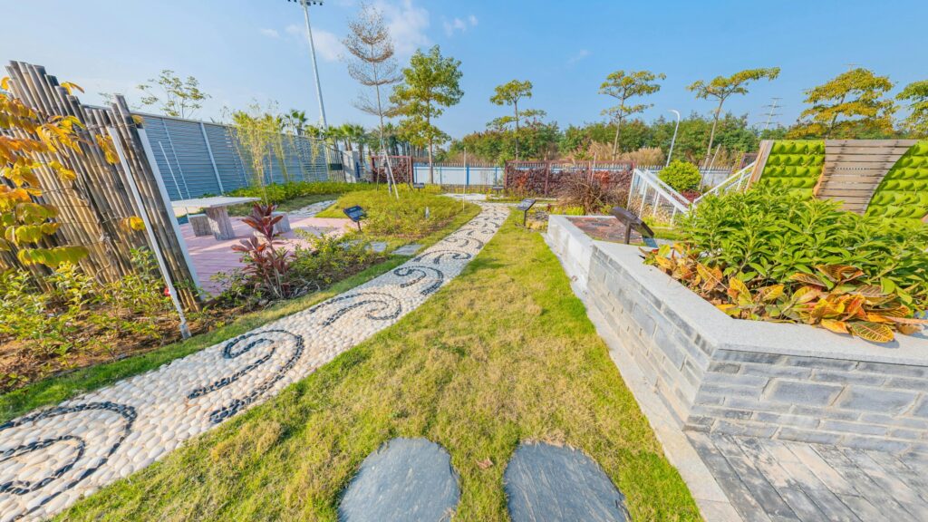 A beautifully landscaped garden with a stone pathway under a clear blue sky.